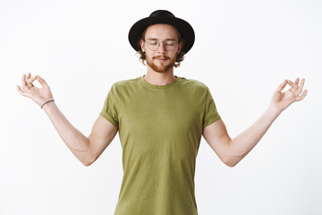 Peace in mind. Portrait of calm and relaxed attractive young bearded man with closed eyes in...