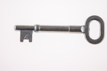 An Old-Fashioned Key on a White Background