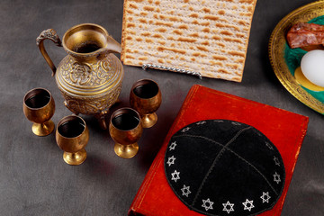 Pesach Passover symbols of great Jewish holiday. Traditional matzoh, matzah or matzo and wine in vintage silver glass.