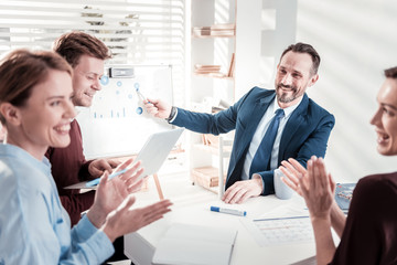 Cheerful four colleagues overcoming challenge