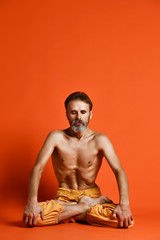Portrait of yogi men doing yoga exercise on black mat, he breath and performing Upward abdominal...