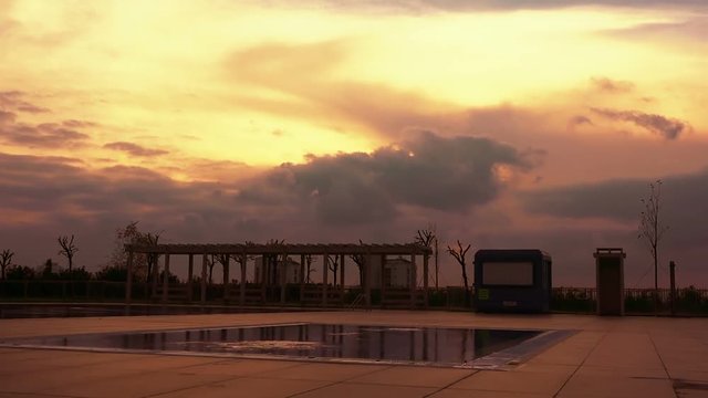Swimming pool in the evening at sunset, beautiful scenic timelapse view