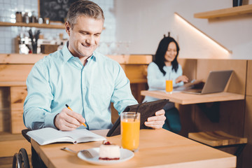 Handsome man having a break in a cafe