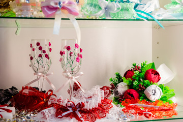 Decorated wedding accessories on a wooden table. A set of wedding accessories, decorated in Colored tapes and jewelry