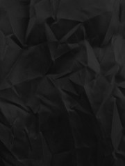 background of close up black color wrinkled clothes, black crumpled textile background