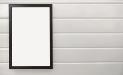 beautiful notification borad hanging on white metal wall, black frame placing on white wall, square black pan on white background