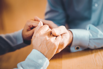 Enamored man and woman holding hands