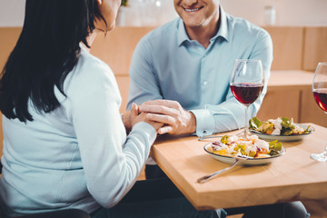 Brunette woman holding a hand of a man