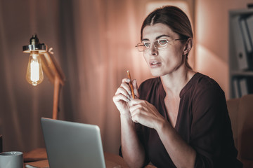 Musing female freelancer editing article