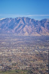 Aerial view of Wasatch Front Rocky Mountain landscapes on flight over Colorado and Utah during winter. Grand sweeping views near the Great Salt Lake, Utah Lake, Provo, Timpanogos, Lone and Twin Peaks 