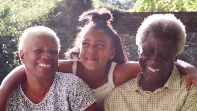 Senior black couple and granddaugther outdoors, close up