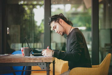 left handed freelance man write project in home working office