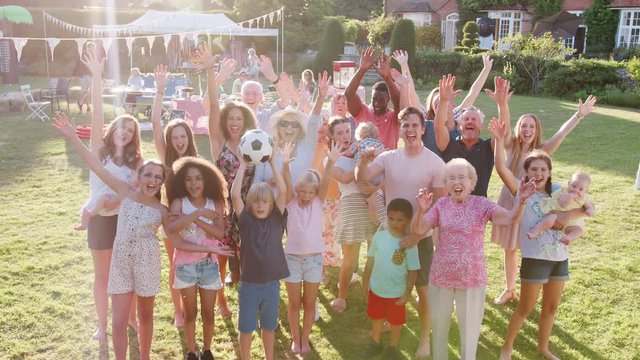 Slow Motion Group Portrait Of People Attending Summer Garden Fete