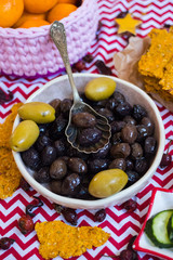 Black olives in bowl with crispy flat corn breads. Vegan and vegetarian healthy products