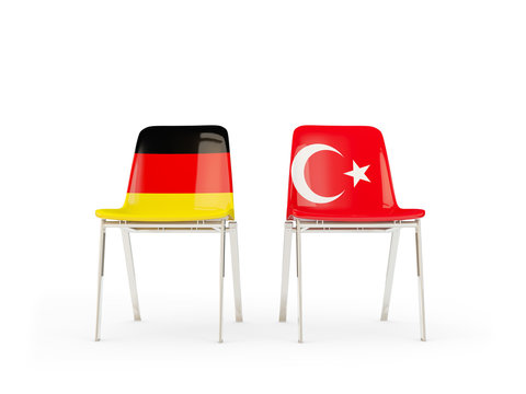 Two chairs with flags of germany and turkey isolated on white