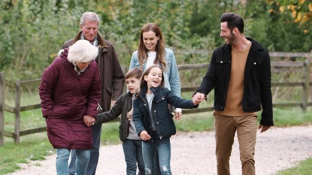 Multi Generation Family On Autumn Walk In Countryside Together