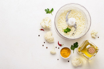 Raw Cauliflower ground in blender bowl. Healthy food background