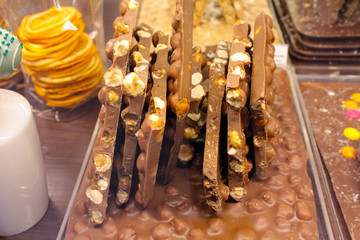 Milk chocolate and nuts in candy shop closeup