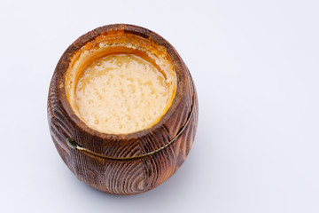 Wooden open barrel with fragrant honey on a white background. Close-up.