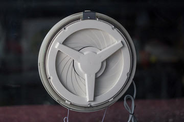 Ventilation fan attached to the glass