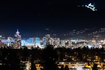 Vancouver city lights with Grouse moutain ski resort on the backgorund