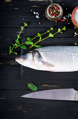 Raw fish. Sea bass on slate blackboard. Ingredients for cooking, grill, baked. Copy space. Top view