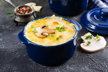 Baked mushroom julienne with chicken and cheese in  pots.
