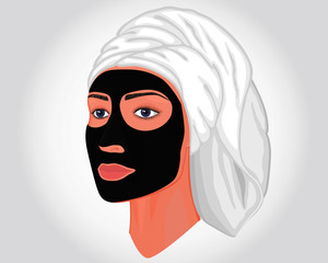 Close-up portrait of a beautiful young woman in half a turn isolated on white background with black cosmetic mask on her face and a towel on her head