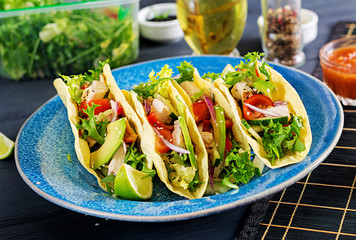 Mexican tacos with chicken meat, avocado, tomato, cucumber and red onion. Healthy tortilla. Wrap food. Taco