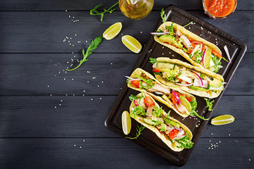 Mexican tacos with chicken meat, avocado, tomato, cucumber and red onion. Healthy tortilla. Wrap food. Taco. Top view