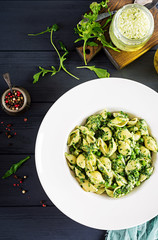 Conchiglie pasta with spinach and green pea pesto. Italian Cuisine. Vegan food. Top view