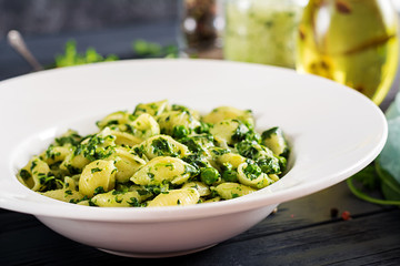 Conchiglie pasta with spinach and green pea pesto. Italian Cuisine. Vegan food.