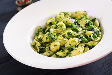 Conchiglie pasta with spinach and green pea pesto. Italian Cuisine. Vegan food.
