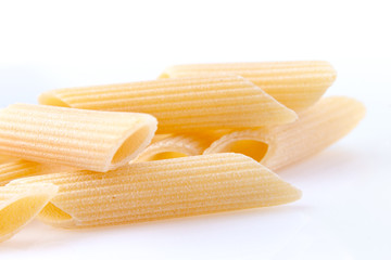 Raw feathers macaroni. Italian pasta close up on the white background