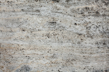 Closeup of beige porous stone textured wall. For background, product designs or skin
