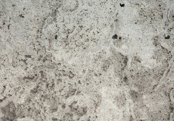 Closeup of beige porous stone textured wall. For background, product designs or skin