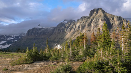Fototapeta na wymiar late afteroon light on mt pollock and bishops cap on a stormy day at glacier national park in montana, usa