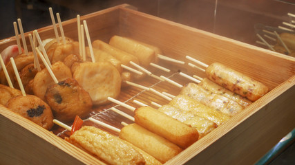 a variety of steamed fishcake for sale at nishiki market in kyoto, japan