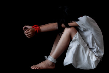 Kidnapped little girl tied with rope.Abused and tortured concept. Human trafficking concept. Stop...