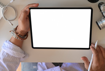 Cropped shot of an unrecognizable man using a tablet. Mockup blank screen tablet