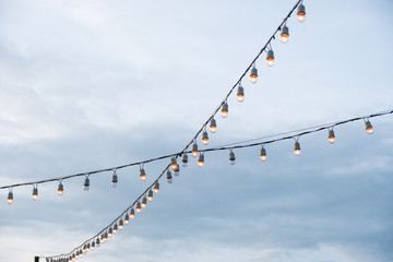 Antique light bulbs crossing with hanging on wire