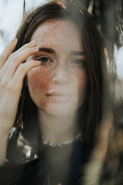 Portrait of a young woman with freckles