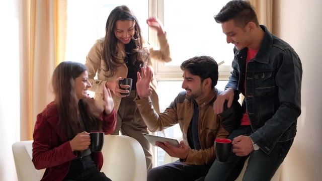 Static shot of coworkers getting successful and giving each other high fives in celebration of their success at business work 