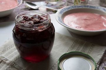 strawberry jam in a jar on an old table