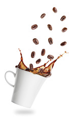 Coffee grains flying into cup of espresso with splash