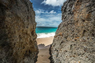 Rocks on the Puka beach, Beautiful azure sea and bright blue sky.