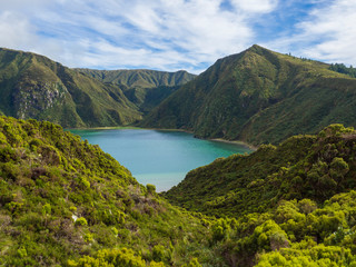 Fototapeta na wymiar Landscape with beautiful blue crater lake Lagoa do Fogo from viewpoint Miradouro da Lagoa do Fogo. Lake of Fire is the highest lake of Sao Miguel island, surrounded by Natural Reserve green forest