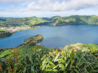 Fototapeta na wymiar view of landscape with green and blue crater lakes of Lagoa Azul and Lagoa Verde and Sete Cidades village in the crater of dormant volcanoes, on Sao Miguel island, Azores, Portugal.