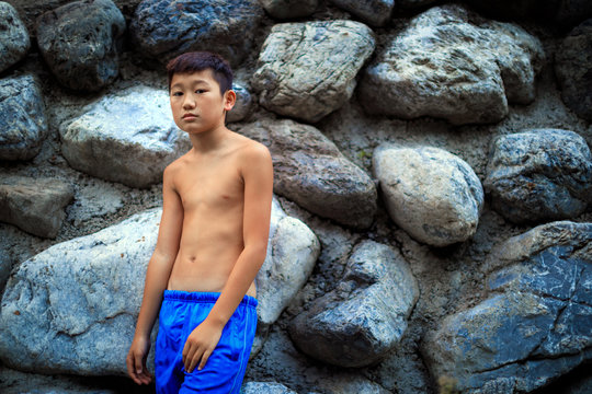 A boy whose upper body is naked.