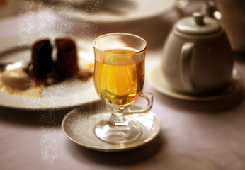 Macro photo of delicious green tea in a glass with cake
